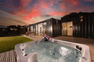 Quartz Cabin viewed from its hot tub under a sunset sky