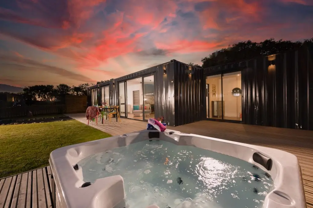 Quartz Cabin viewed from its hot tub under a sunset sky