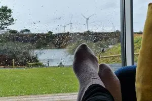 Feet up on the couch with the view of the lake in the background